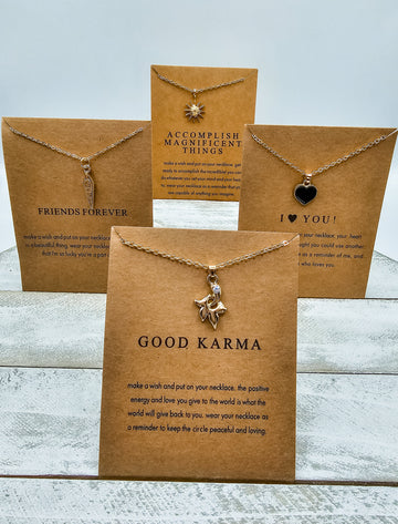 Picture of 4 positivity inspired necklaces with message cards.